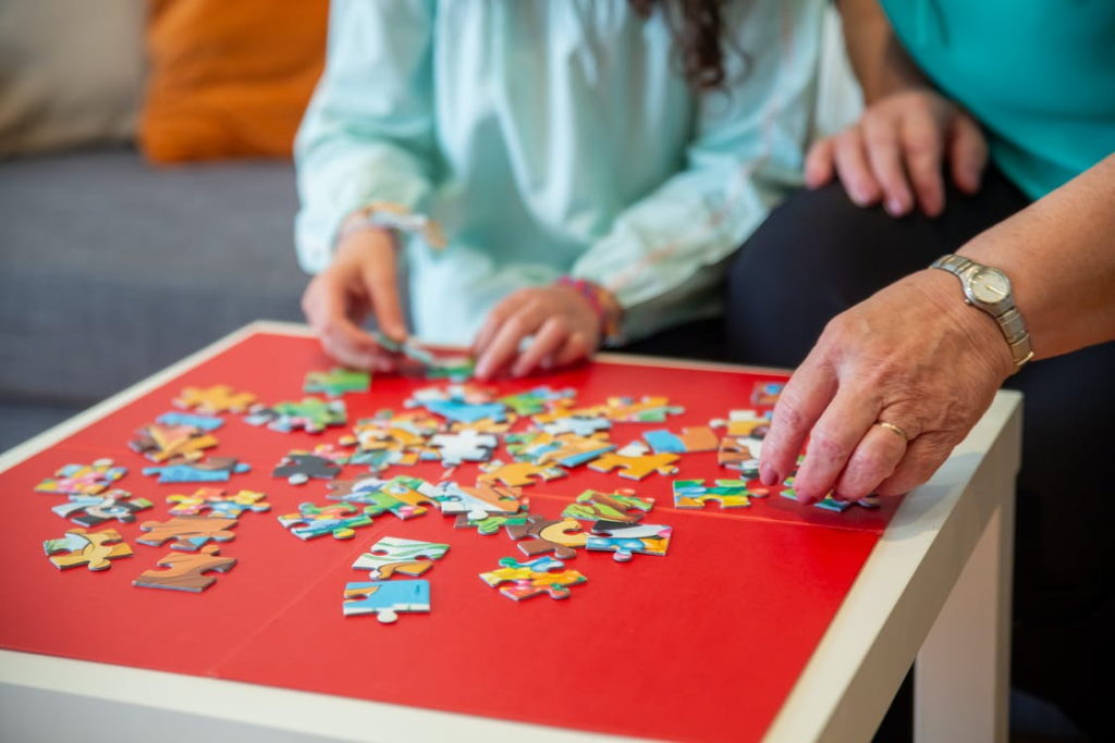 A senior putting together a puzzle