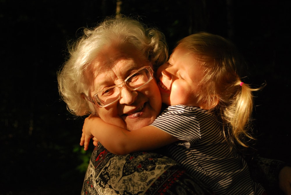  A little girl hugging her grandmother.