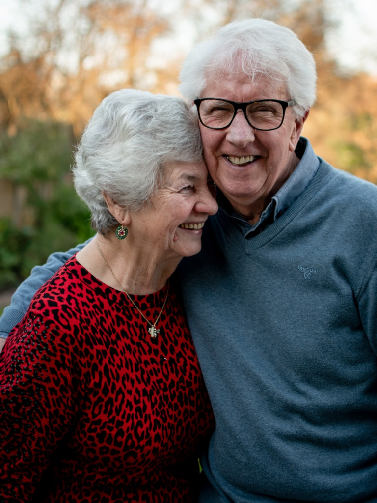 A smiling elderly couple.