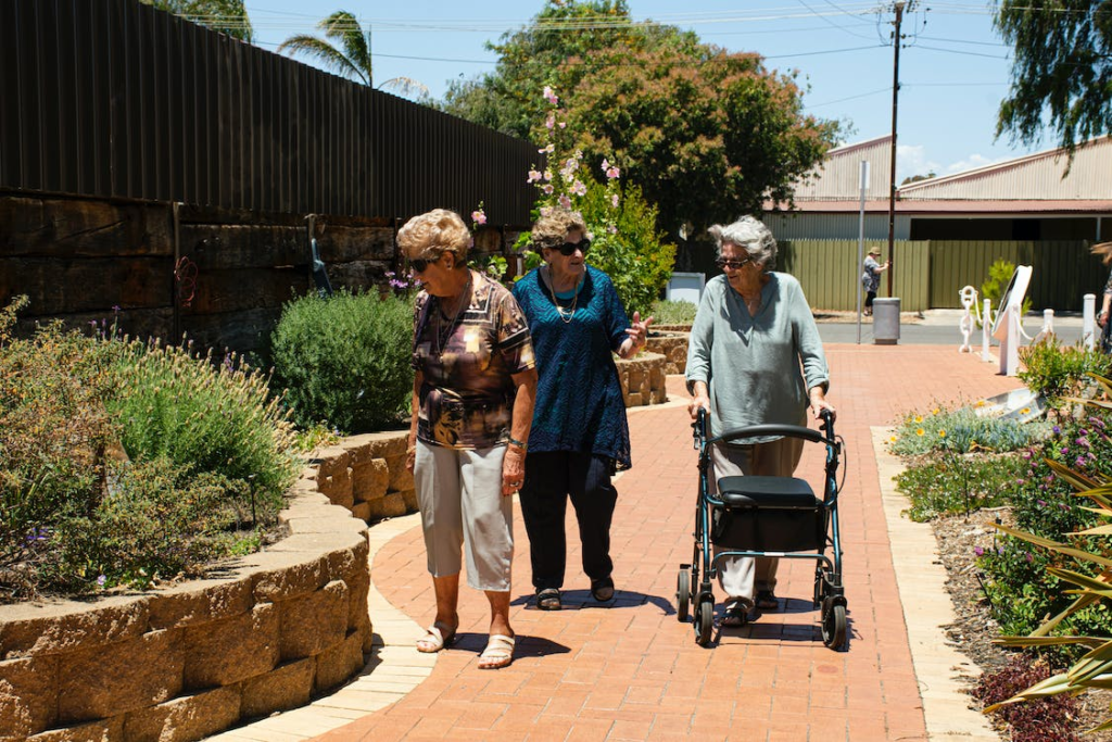 A group of seniors walking along a walkway