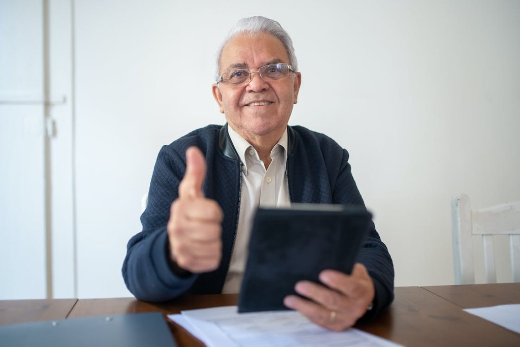 A senior giving a thumbs up