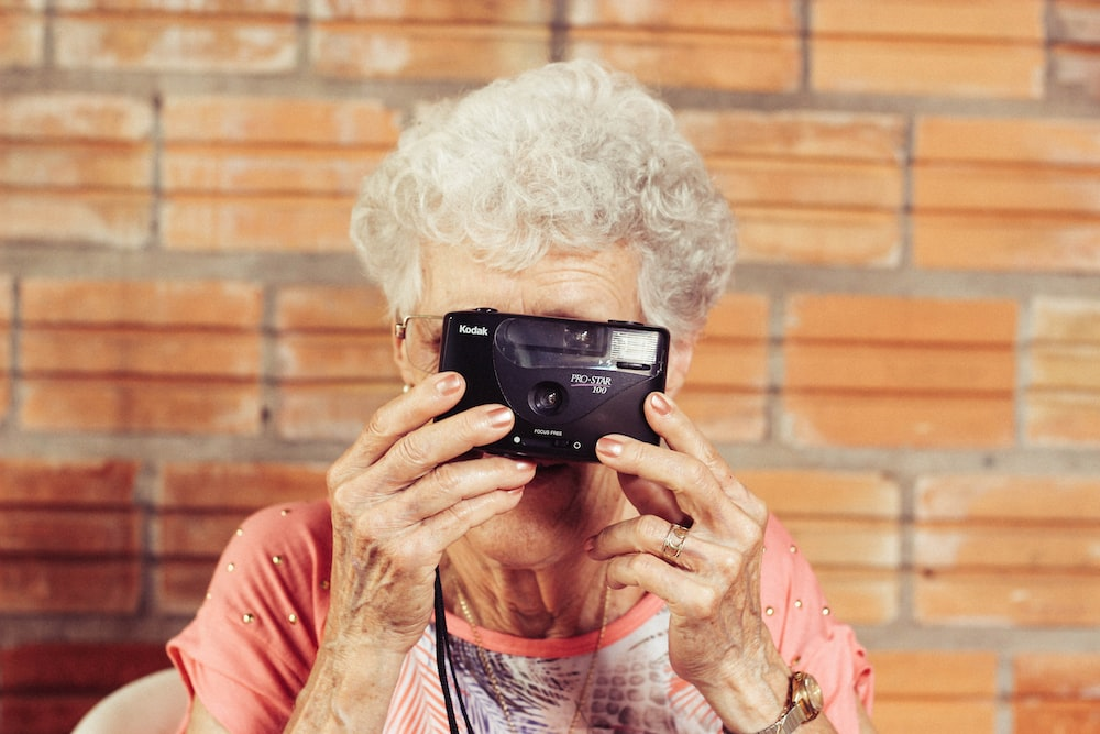  a senior woman holding a camera. 