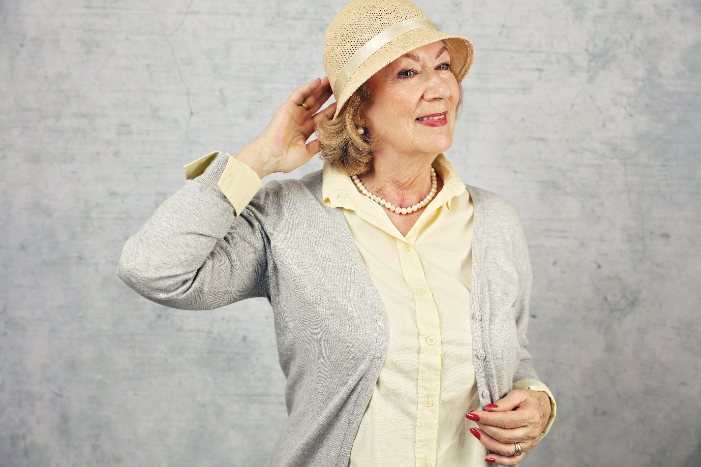 A senior wearing a luxurious outfit with a hat