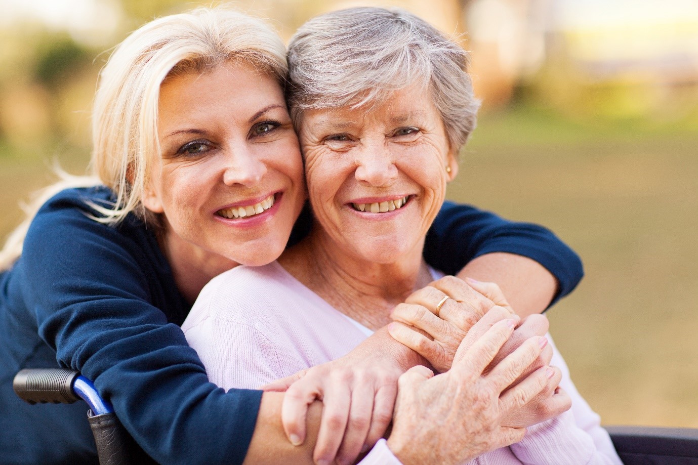 A senior smiling with their caregiver 