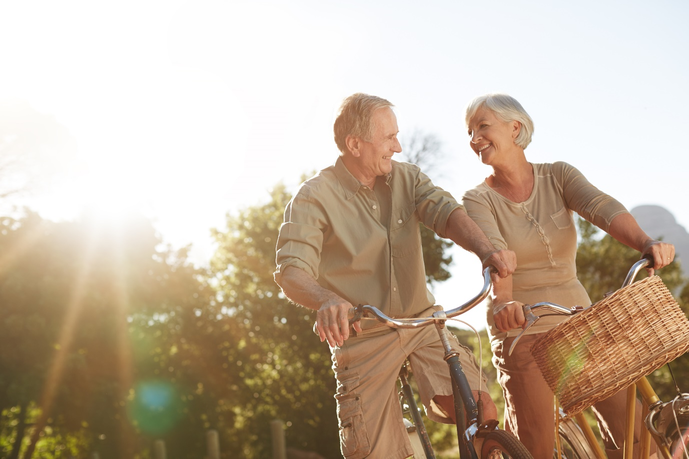 A senior couple riding bicycles outdoors