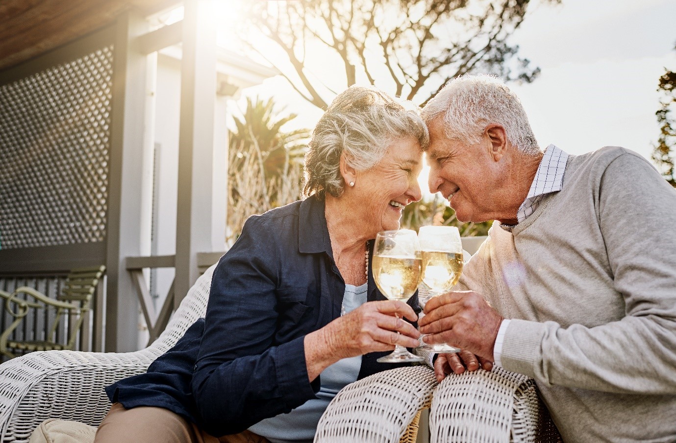 A senior couple holding drinks