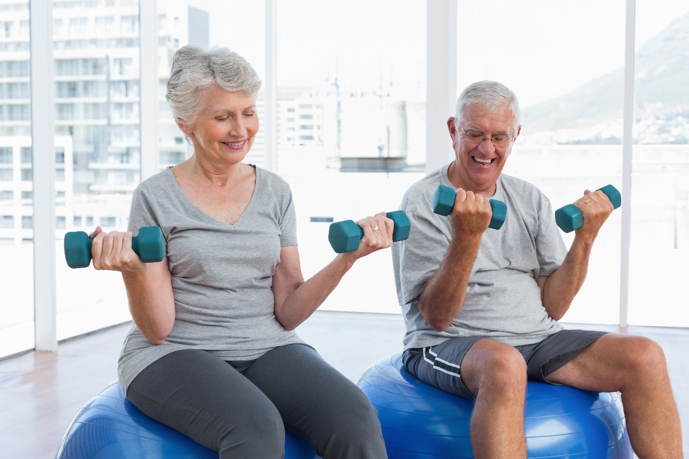 A pair of seniors lifting weights